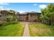 Spacious backyard with a brick patio, green lawn, and mature landscaping at 346 N Corona St, Denver, CO 80218