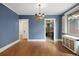 Classic dining room with hardwood floors, blue walls, and a vintage chandelier fixture at 346 N Corona St, Denver, CO 80218