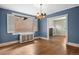 Charming dining room with a gold chandelier, blue walls, and bright window at 346 N Corona St, Denver, CO 80218