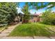 Charming brick home with lush green lawn and mature trees at 346 N Corona St, Denver, CO 80218