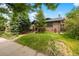 Charming brick home with lush green lawn and mature trees at 346 N Corona St, Denver, CO 80218