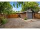 Detached brick garage with gray door and off-street parking area at 346 N Corona St, Denver, CO 80218