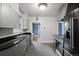 Stylish kitchen with black appliances, black countertops, and adjacent blue-painted dining room at 346 N Corona St, Denver, CO 80218