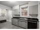Vintage kitchen featuring gray cabinetry, stainless steel sink, and neutral-toned walls at 346 N Corona St, Denver, CO 80218