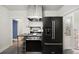 Compact kitchen with stainless steel appliances, tile flooring, and retro-style cabinetry at 346 N Corona St, Denver, CO 80218