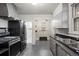 Functional kitchen with stainless steel appliances, tile flooring, and vintage cabinetry at 346 N Corona St, Denver, CO 80218
