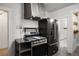 Modern kitchen with stainless steel range, hood, and refrigerator and gray tile flooring at 346 N Corona St, Denver, CO 80218