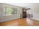 Cozy living room with hardwood floors, a large window, and an inviting front door entrance at 346 N Corona St, Denver, CO 80218