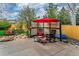 Outdoor seating area featuring lattice privacy wall, a red umbrella, and stone-paved patio at 2225 Clayton Cir, Superior, CO 80027