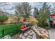Well-maintained backyard with stone path, bench with pillows, mature trees, and privacy fence at 2225 Clayton Cir, Superior, CO 80027