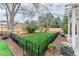 A fenced yard with an outdoor seating area surrounded by a lush green lawn and mature trees at 2225 Clayton Cir, Superior, CO 80027