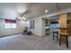 Open basement area with a rocking chair, table, bar seating, and neutral carpet at 2225 Clayton Cir, Superior, CO 80027