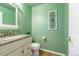 Well-lit powder room with granite vanity and modern fixtures, decorated in a soft green at 2225 Clayton Cir, Superior, CO 80027