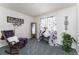 Comfortable bedroom featuring plush carpet, a rocking chair, and natural light filtering through stylish floral curtains at 2225 Clayton Cir, Superior, CO 80027