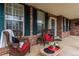 Inviting front porch with brick accents, comfortable seating, and decorative plants at 2225 Clayton Cir, Superior, CO 80027