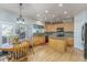 Bright eat-in kitchen featuring light wood cabinetry, stainless appliances, tile backsplash, and access to the rear patio at 2225 Clayton Cir, Superior, CO 80027