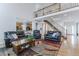 Open-concept living room featuring hardwood floors, comfortable seating, and a view of the kitchen at 2225 Clayton Cir, Superior, CO 80027