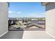 Balcony view overlooking rooftops with mountain views in the distance on a clear, sunny day at 22 Oneida Ct, Denver, CO 80230