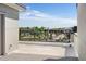 Balcony view overlooking rooftops and commercial area in the distance on a clear, sunny day at 22 Oneida Ct, Denver, CO 80230