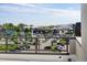 Balcony view overlooking parking lot and commercial area in the distance on a clear, sunny day at 22 Oneida Ct, Denver, CO 80230