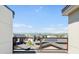 Balcony view overlooking rooftops with mountain views in the distance on a clear, sunny day at 22 Oneida Ct, Denver, CO 80230