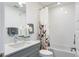 Well-lit bathroom with modern fixtures, white subway tile, and shower/tub combo at 22 Oneida Ct, Denver, CO 80230