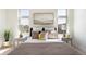 Serene bedroom featuring a comfortable bed with decorative pillows, side tables, and natural light at 22 Oneida Ct, Denver, CO 80230