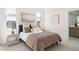 Bright bedroom features modern decor, cozy bedding, and ample natural light with ensuite bathroom at 22 Oneida Ct, Denver, CO 80230