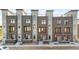 Exterior view of modern townhomes featuring brick and stucco facades at 22 Oneida Ct, Denver, CO 80230