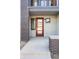 Close-up of the front entrance with a modern red door, brick accents, and a well-maintained walkway at 22 Oneida Ct, Denver, CO 80230