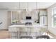 Modern kitchen featuring a large island with seating, stainless steel appliances, and stylish pendant lighting at 22 Oneida Ct, Denver, CO 80230