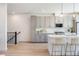 Modern kitchen boasts sleek gray cabinets, stainless appliances, quartz counters, and stylish pendant lighting at 22 Oneida Ct, Denver, CO 80230