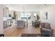 Bright open floor plan features updated kitchen, adjacent dining area, and stylish living space with hardwood floors at 22 Oneida Ct, Denver, CO 80230