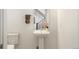 Half bathroom showcasing a pedestal sink and modern fixtures at 22 Oneida Ct, Denver, CO 80230