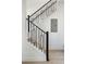 Staircase with carpet steps and wrought iron railing at 22 Oneida Ct, Denver, CO 80230