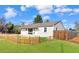 Charming single-story home featuring a well-manicured lawn and a cute picket fence at 795 Moline St, Aurora, CO 80010