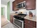 Modern kitchen boasting stainless steel appliances, granite countertops, and dark wood cabinets, ideal for cooking enthusiasts at 795 Moline St, Aurora, CO 80010