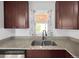 Kitchen featuring a stainless steel sink, granite countertops, and dark cabinetry, offering both style and functionality at 795 Moline St, Aurora, CO 80010