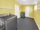 Well-equipped laundry room featuring modern washer and dryer, storage shelves, and ample space for efficient laundry management at 795 Moline St, Aurora, CO 80010