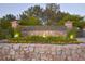 Stonegate community entrance featuring a stone sign with colorful flowerbeds and lush landscaping at 10429 White Pine Dr, Parker, CO 80134