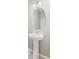 Bathroom featuring modern pedestal sink and a beveled oval mirror at 18029 Dandy Brush Ln, Parker, CO 80134