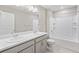 Bright bathroom featuring double vanity, large mirror, and shower/bathtub combination with white tile at 18029 Dandy Brush Ln, Parker, CO 80134