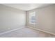 Bright bedroom featuring neutral walls, carpet, white trim, and a window offering natural light at 18029 Dandy Brush Ln, Parker, CO 80134