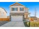 Charming two-story home with stone accents and a two-car garage, presenting a welcoming curb appeal at 18029 Dandy Brush Ln, Parker, CO 80134