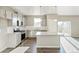 Bright kitchen features stainless appliances, gray cabinets, granite countertops, and wood grain floors at 18029 Dandy Brush Ln, Parker, CO 80134