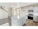 Kitchen area includes gray cabinets, granite countertops, stainless appliances, and wood grain floors at 18029 Dandy Brush Ln, Parker, CO 80134