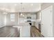 Bright kitchen features stainless appliances, gray cabinets, granite countertops, and wood grain floors at 18029 Dandy Brush Ln, Parker, CO 80134