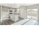 Bright kitchen features stainless appliances, gray cabinets, granite countertops, and wood grain floors at 18029 Dandy Brush Ln, Parker, CO 80134
