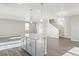 Open kitchen features gray cabinets, granite countertops, stainless appliances, and wood grain floors at 18029 Dandy Brush Ln, Parker, CO 80134