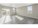 Bright, airy living room with sleek floors and multiple windows, offering ample natural light at 18029 Dandy Brush Ln, Parker, CO 80134